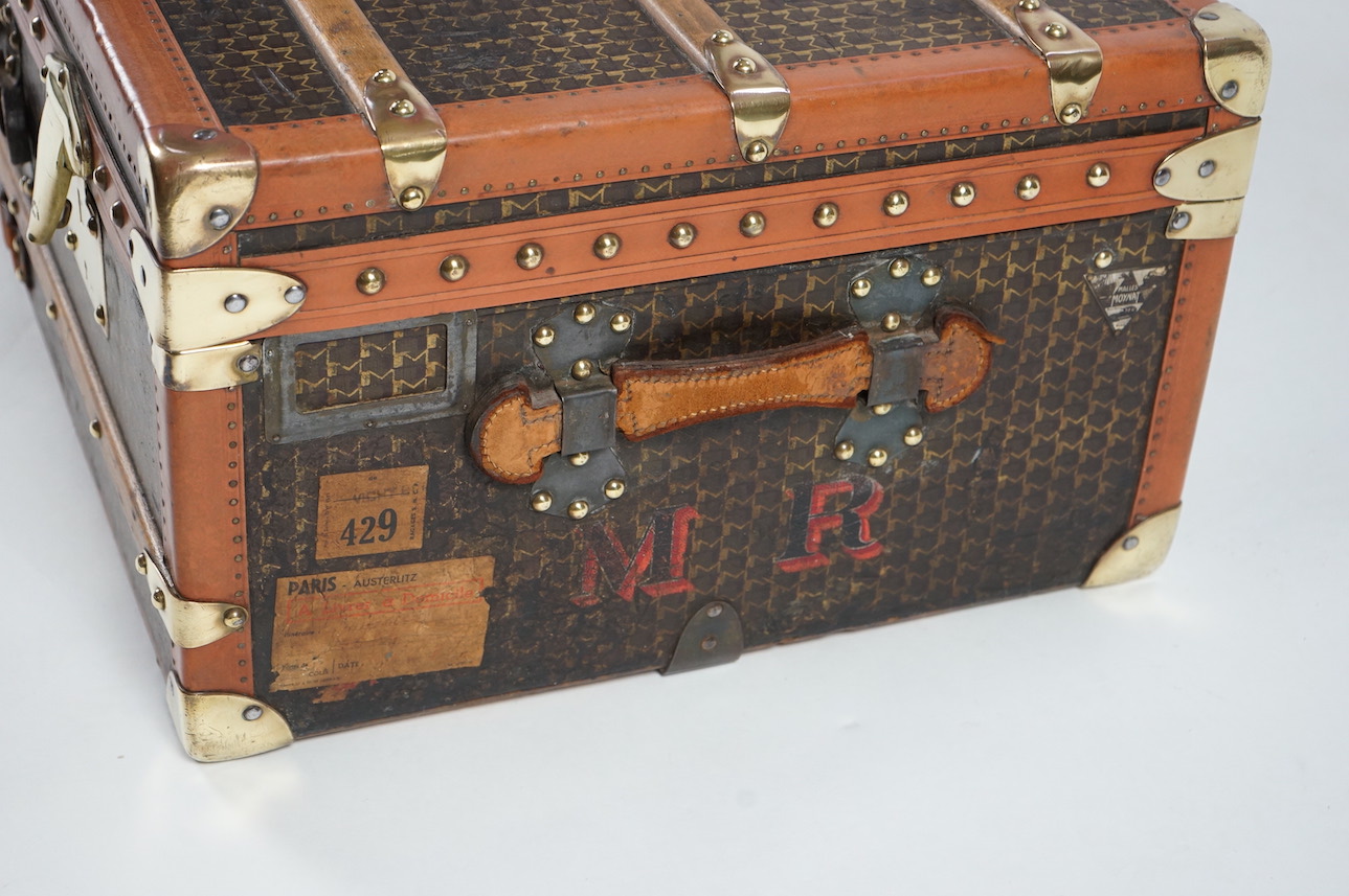 A vintage Moynat cabin trunk, with brass mounts, wooden slats and tan leather bound M motif canvas, the interior with quilted lining inside the lid and two canvas trays, 90cm wide, 53cm deep, 33cm high. Condition - very